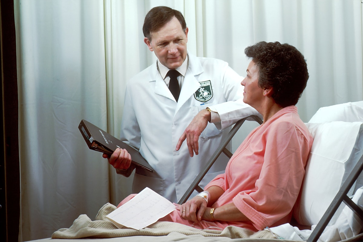 Pediatrician examining young child patient during routine wellness visit