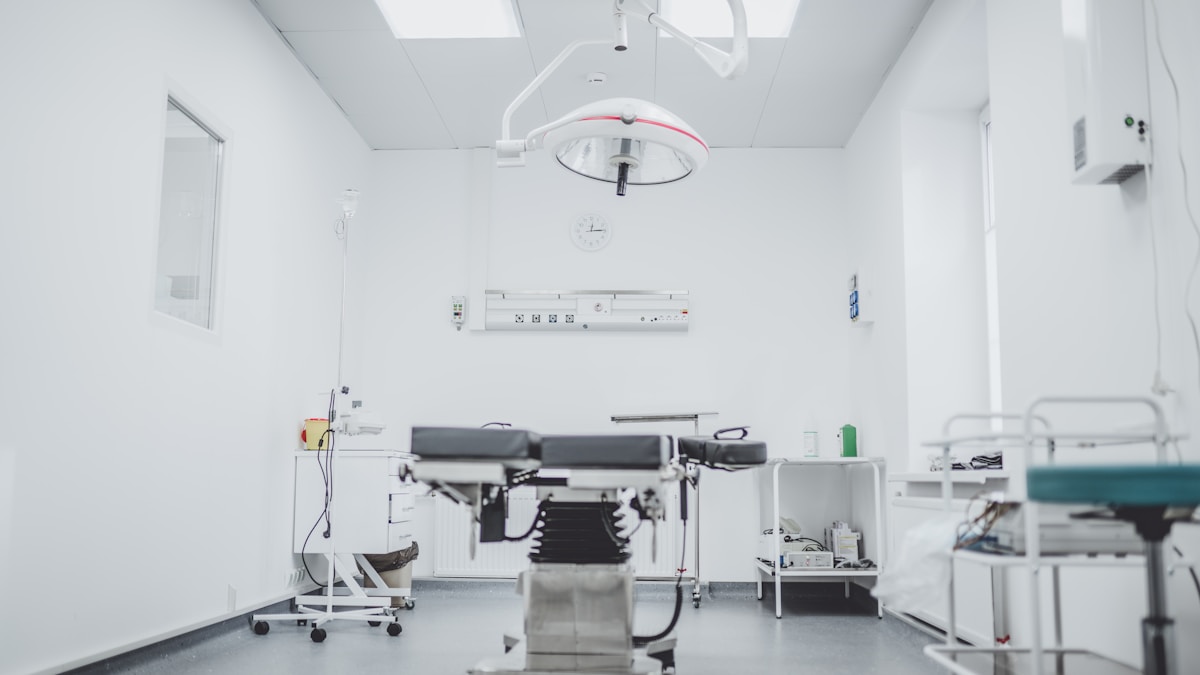 Anesthesiologist monitoring patient vital signs during surgical procedure